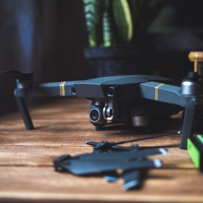 close up quadrocopter device kit on a wooden surface with dark background